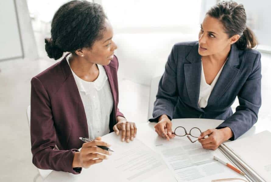 A startup CEO and her chief of staff having a meeting at a table